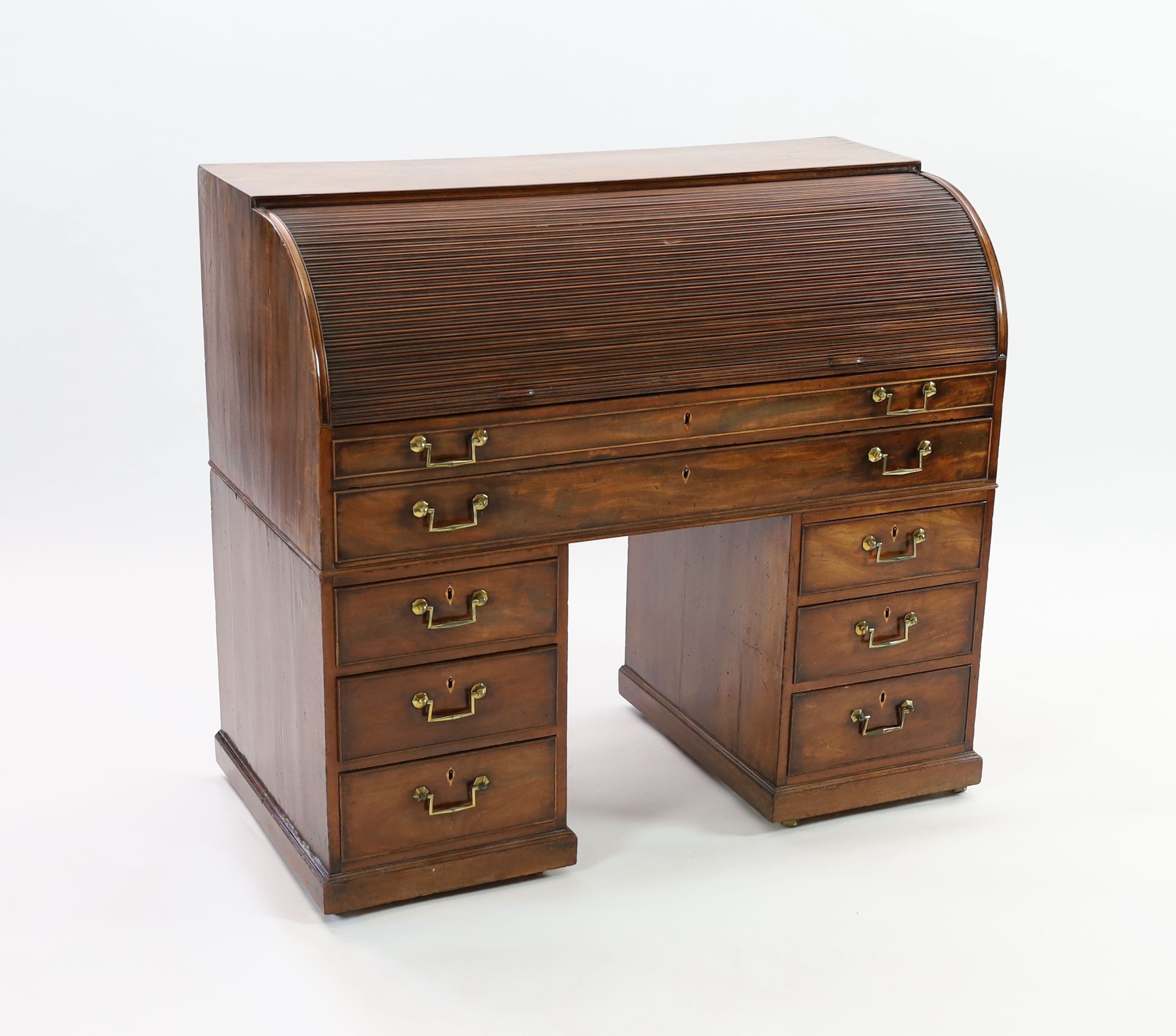 A George III mahogany cylinder top combined writing and dressing kneehole desk, W.122cm D.61cm H.110cm